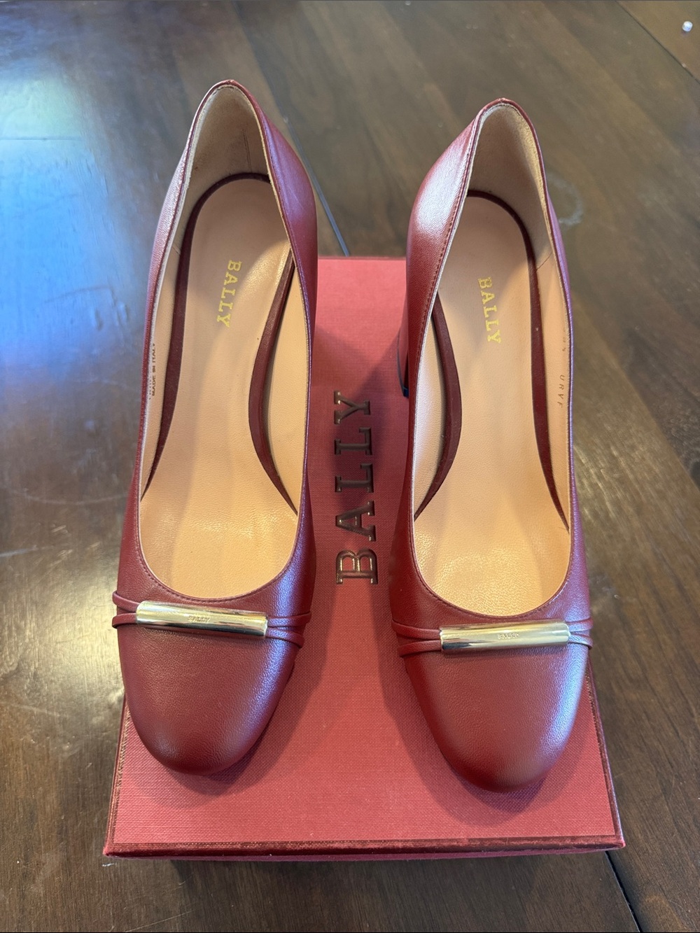 Bally Burgundy Leather Pumps with Gold Bar